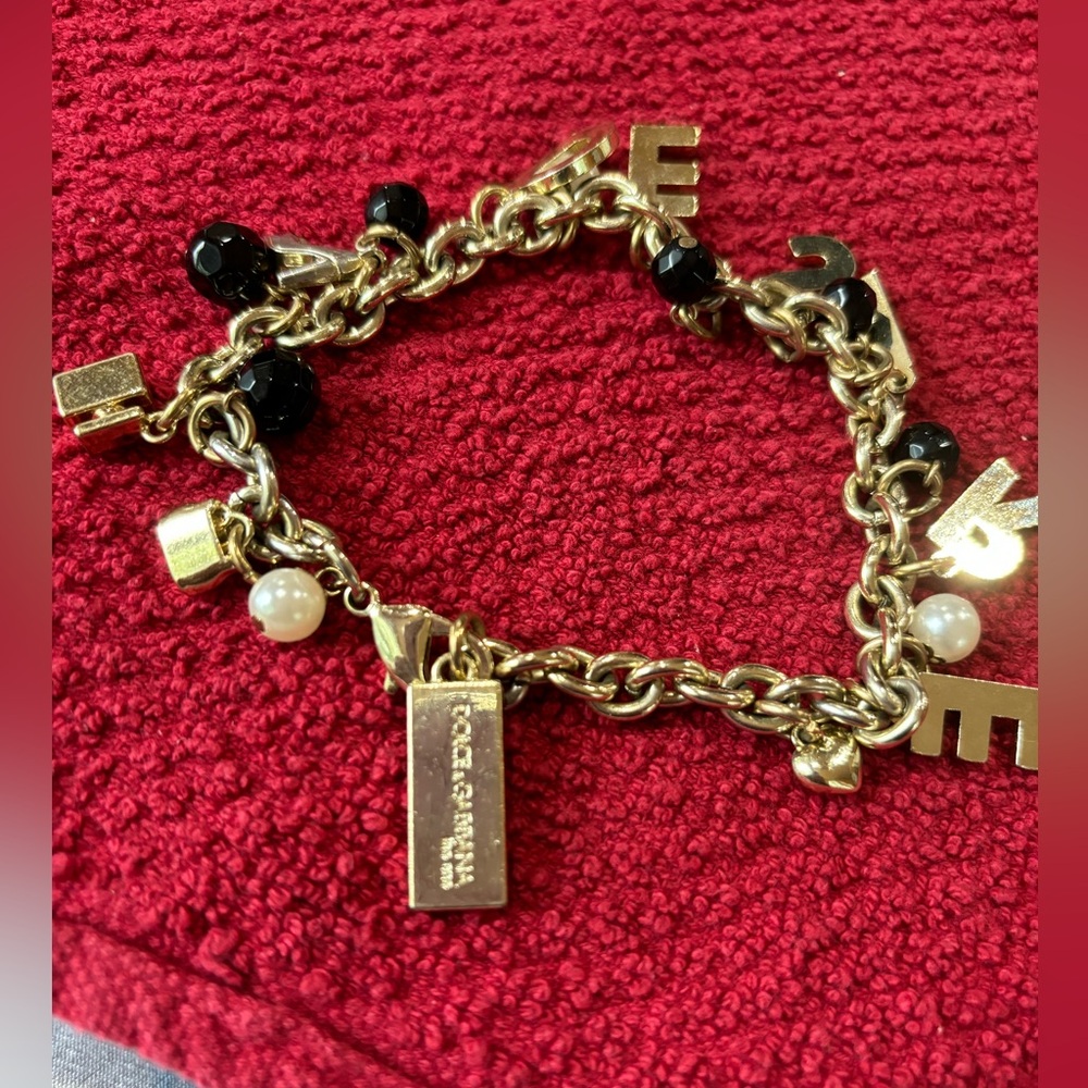 Dolce and Gabbana DESIRE charm bracelet. EUC tones of black gold and pearl.